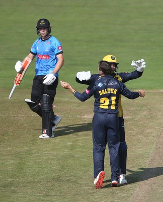 260819 - Glamorgan v Sussex Sharks - Vitality T20 Blast - Andrew Salter and Chris Cooke of Glamorgan celebrate as Phil Salt of Sussex is bowled out