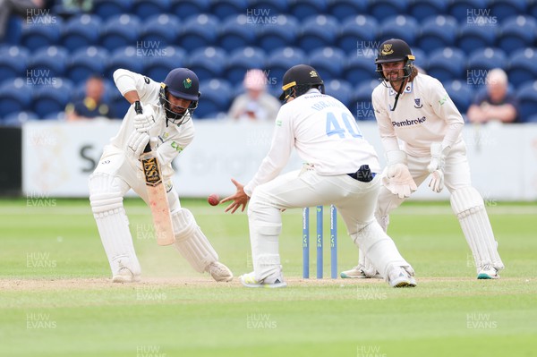 270623 - Glamorgan v Sussex, LV= Insurance County Championship, Div 2 - Zain ul Hassan of Glamorgan plays a shot past Danial Ibrahim of Sussex as Oli Carter of Sussex looks on