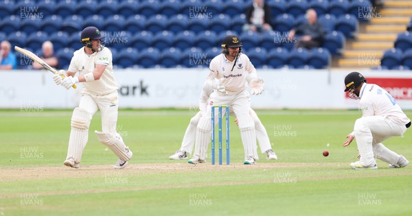 270623 - Glamorgan v Sussex, LV= Insurance County Championship, Div 2 - Sam Northeast of Glamorgan plays a shot past Danial Ibrahim of Sussex as Oli Carter of Sussex looks on