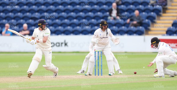 270623 - Glamorgan v Sussex, LV= Insurance County Championship, Div 2 - Sam Northeast of Glamorgan plays a shot past Danial Ibrahim of Sussex as Oli Carter of Sussex looks on