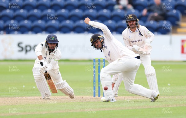 270623 - Glamorgan v Sussex, LV= Insurance County Championship, Div 2 - Zain ul Hassan of Glamorgan plays a shot past Danial Ibrahim of Sussex as Oli Carter of Sussex looks on