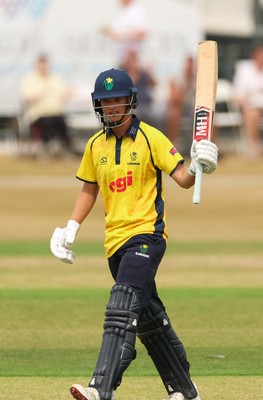 220726 - Glamorgan v Sussex Sharks, Metro Bank One Day Cup - Jack Hope-Bell of Glamorgan raises his bat as he reaches his 50 runs