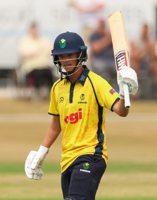 220726 - Glamorgan v Sussex Sharks, Metro Bank One Day Cup - Jack Hope-Bell of Glamorgan raises his bat as he reaches his 50 runs