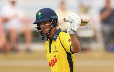 220726 - Glamorgan v Sussex Sharks, Metro Bank One Day Cup - Jack Hope-Bell of Glamorgan raises his bat as he reaches his 50 runs