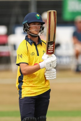 220726 - Glamorgan v Sussex Sharks, Metro Bank One Day Cup - Jack Hope-Bell of Glamorgan raises his bat as he reaches his 50 runs