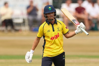 220726 - Glamorgan v Sussex Sharks, Metro Bank One Day Cup - Jack Hope-Bell of Glamorgan raises his bat as he reaches his 50 runs