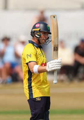 220726 - Glamorgan v Sussex Sharks, Metro Bank One Day Cup - Alex Horton of Glamorgan  raises his bat as he reaches his 50 runs