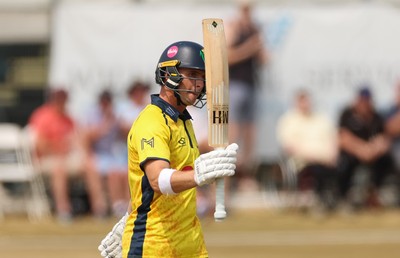 220726 - Glamorgan v Sussex Sharks, Metro Bank One Day Cup - Alex Horton of Glamorgan  raises his bat as he reaches his 50 runs