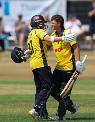 220726 - Glamorgan v Sussex Sharks, Metro Bank One Day Cup - Jack Hope-Bell of Glamorgan, right, celebrates with Alex Horton of Glamorgan, as he reaches his maiden 100 runs