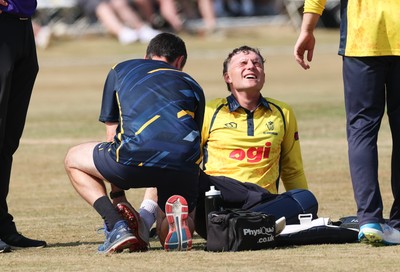 220726 - Glamorgan v Sussex Sharks, Metro Bank One Day Cup - Alex Horton of Glamorgan  receives treatment after picking up an injury