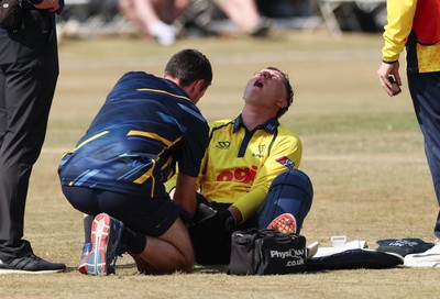 220726 - Glamorgan v Sussex Sharks, Metro Bank One Day Cup - Alex Horton of Glamorgan  receives treatment after picking up an injury