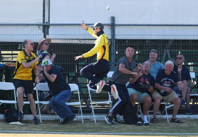 220726 - Glamorgan v Sussex Sharks, Metro Bank One Day Cup - Eddie Byrom of Glamorgan looks to catch the ball as spectators look to take cover