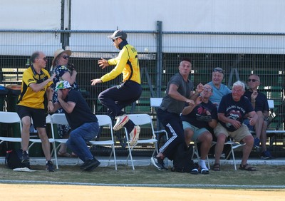 220726 - Glamorgan v Sussex Sharks, Metro Bank One Day Cup - Eddie Byrom of Glamorgan looks to catch the ball as spectators look to take cover