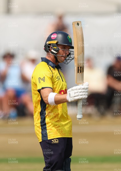 220726 - Glamorgan v Sussex Sharks, Metro Bank One Day Cup - Alex Horton of Glamorgan  raises his bat as he reaches his 50 runs