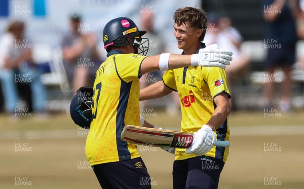 220726 - Glamorgan v Sussex Sharks, Metro Bank One Day Cup - Jack Hope-Bell of Glamorgan, right, celebrates with Alex Horton of Glamorgan, as he reaches his maiden 100 runs