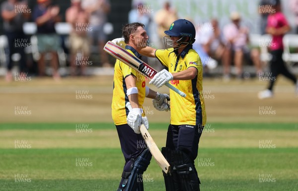 220726 - Glamorgan v Sussex Sharks, Metro Bank One Day Cup - Alex Horton of Glamorgan celebrates as he reaches his maiden 100 runs with Jack Hope-Bell of Glamorgan