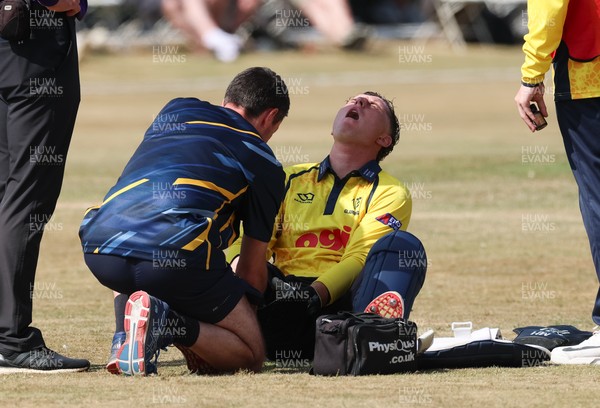 220726 - Glamorgan v Sussex Sharks, Metro Bank One Day Cup - Alex Horton of Glamorgan  receives treatment after picking up an injury
