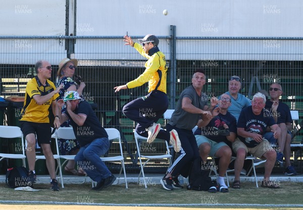 220726 - Glamorgan v Sussex Sharks, Metro Bank One Day Cup - Eddie Byrom of Glamorgan looks to catch the ball as spectators look to take cover