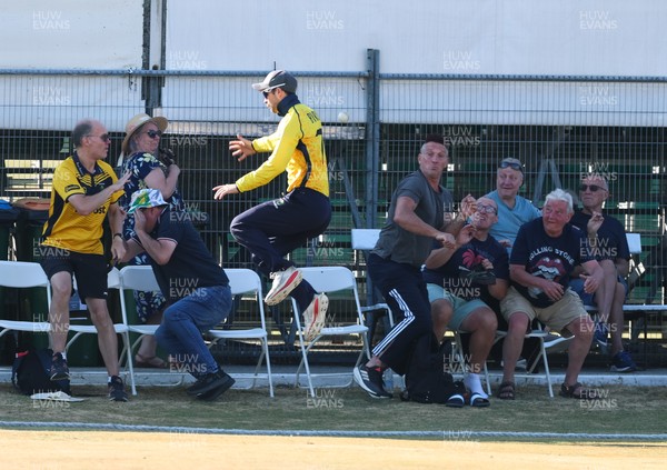 220726 - Glamorgan v Sussex Sharks, Metro Bank One Day Cup - Eddie Byrom of Glamorgan looks to catch the ball as spectators look to take cover