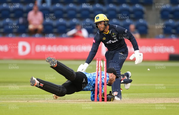 020721 - Glamorgan v Sussex Sharks, T20 Vitality Blast - Phil Salt of Sussex Sharks dives for the stumps as Colin Ingram of Glamorgan is run out by Tymal Mills for 3 runs