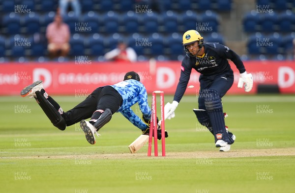 020721 - Glamorgan v Sussex Sharks, T20 Vitality Blast - Phil Salt of Sussex Sharks dives for the stumps as Colin Ingram of Glamorgan is run out by Tymal Mills for 3 runs