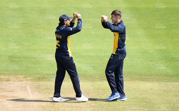 220721 - Glamorgan v Warwickshire - Royal London Cup - Callum Taylor (right) of Glamorgan celebrates the wicket of Chris Benjamin