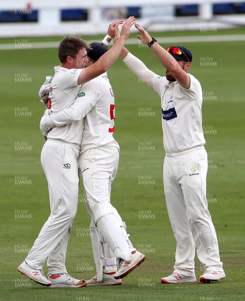 010719 - Glamorgan v Worcestershire - Specsavers County Championship Division Two - Dan Douthwaite of Glamorgan celebrates with team mates Tom Cullen and David Lloyd after he bowled Callum Ferguson