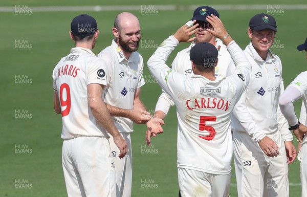 100923 - Glamorgan v Yorkshire, LV= County Championship, Division 2 - Jamie McIlroy of Glamorgan is congratulated by team mates after bowling out Adam Lyth of Yorkshire