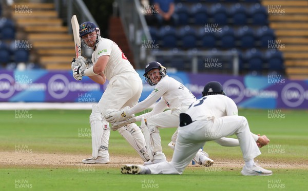120923 - Glamorgan v Yorkshire, LV= County Championship, Division 2 - Dan Douthwaite of Glamorgan and Jonathan Tattersall of Yorkshire look on as Finlay Bean of Yorkshire takes the ball