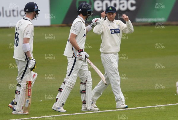 140521 - Glamorgan v Yorkshire, LV= County Championship Group Three - Billy Root of Glamorgan gets a fist bump from brother Joe Root of Yorkshire after he is presented with his Glamorgan County cap as the players take to the pitch for the final session of the day's play