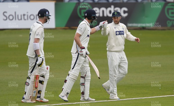 140521 - Glamorgan v Yorkshire, LV= County Championship Group Three - Billy Root of Glamorgan gets a fist bump from brother Joe Root of Yorkshire after he is presented with his Glamorgan County cap as the players take to the pitch for the final session of the day's play