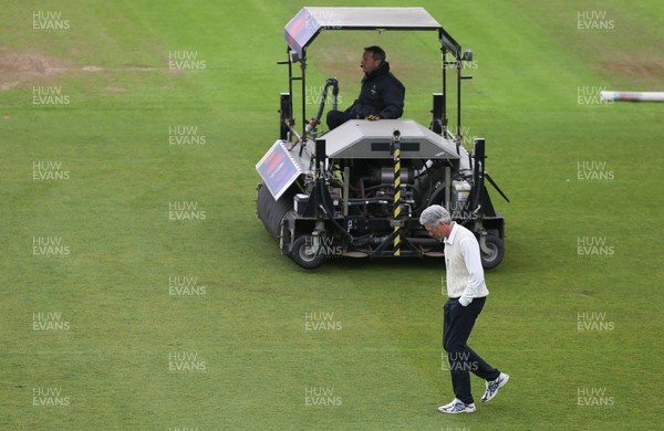 150521 - Glamorgan v Yorkshire, LV= County Championship Group Three - The umpire inspects the outfield as work continues to prepare the ground for play