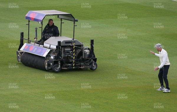 150521 - Glamorgan v Yorkshire, LV= County Championship Group Three - The umpire inspects the outfield as work continues to prepare the ground for play