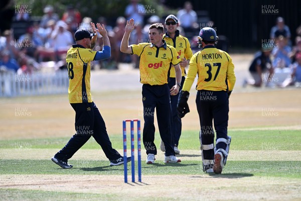 240726 - Glamorgan v Yorkshire - Metro Bank One Day Cup Men - Andy Gorvin of Glamorgan bowls the ball to dismiss George Hill of Yorkshire