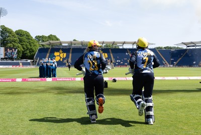 230526 - Glamorgan Women v Derbyshire Falcons Women, Vitality Blast Women League 2 - Lauren Parfitt of Glamorgan Women and Daisy Jeanes of Glamorgan Women make their way out at the start of the match