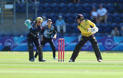 130725 -  Glamorgan Women v Gloucestershire Women, Vitality Blast Women League 2, South Group - Georgia Parfitt of Glamorgan Women takes the ball as Bea Willis of Gloucestershire Women looks on