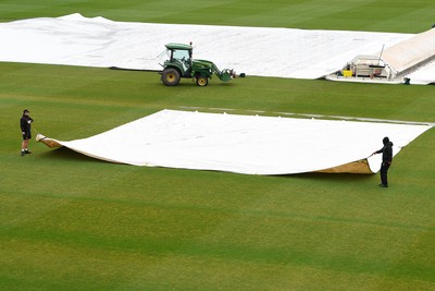 190425 - Glamorgan Women v Sussex Women - Metro Bank One Day Cup - The Groundsmen prepare to clear the field so play can start