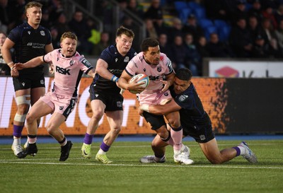 080526 - Glasgow Warriors v Cardiff Rugby - United Rugby Championship - Ben Thomas of Cardiff is tackled by Sione Tuipulotu of Glasgow 