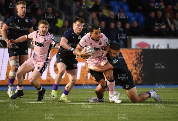 080526 - Glasgow Warriors v Cardiff Rugby - United Rugby Championship - Ben Thomas of Cardiff is tackled by Sione Tuipulotu of Glasgow 