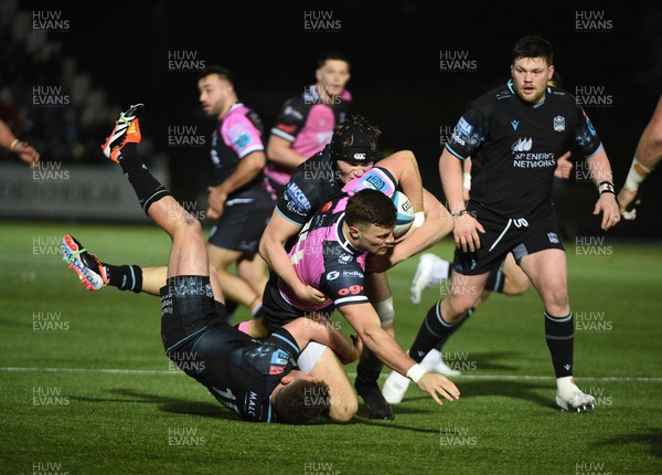 220324 - Glasgow Warriors v Cardiff Rugby - United Rugby Championship - Mason Grady of Cardiff Rugby winger causes havoc in the Glasgow Warriors defence as Duncan Weir (10) attempts to haul him down
