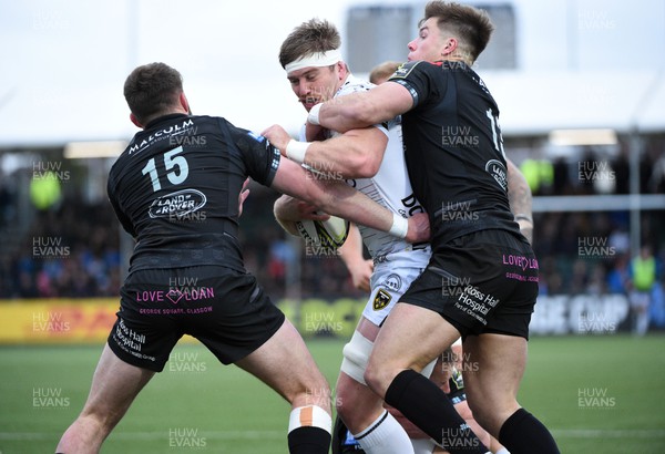 010423 - Glasgow Warriors v Dragons RFC - EPCR Challenge Cup - Aaron Wainwright of Dragons is tackled by Oliver Smith and Huw Jones of Glasgow