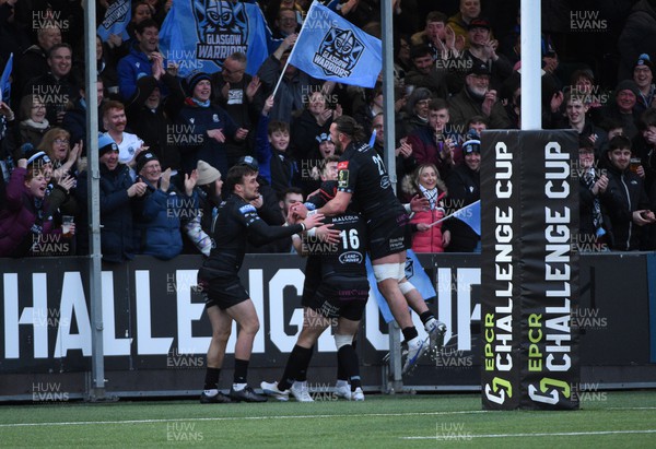 010423 - Glasgow Warriors v Dragons RFC - EPCR Challenge Cup - Huw Jones of Glasgow celebrates his second half try with Ryan Wilson as the fans are ecstatic