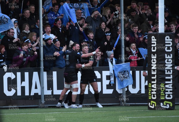 010423 - Glasgow Warriors v Dragons RFC - EPCR Challenge Cup - Huw Jones of Glasgow celebrates his second half try with Ryan Wilson as the fans are ecstatic