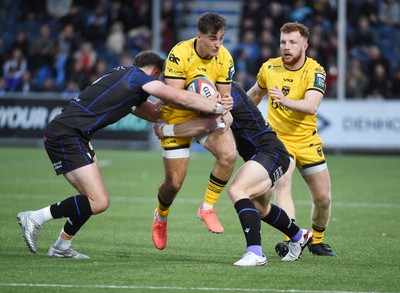 111025 - Glasgow Warriors v Dragons RFC - United Rugby Championship - Harri Ackerman of Dragons tackled by Ollie Smith of Glasgow Warriors and Kyle Steyn of Glasgow Warriors