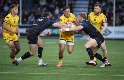 111025 - Glasgow Warriors v Dragons RFC - United Rugby Championship - Harri Ackerman of Dragons tackled by Ollie Smith of Glasgow Warriors and Kyle Steyn of Glasgow Warriors