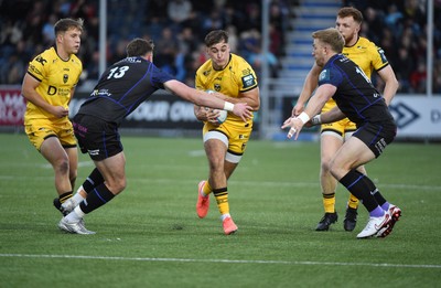 111025 - Glasgow Warriors v Dragons RFC - United Rugby Championship - Harri Ackerman of Dragons tackled by Ollie Smith of Glasgow Warriors and Kyle Steyn of Glasgow Warriors