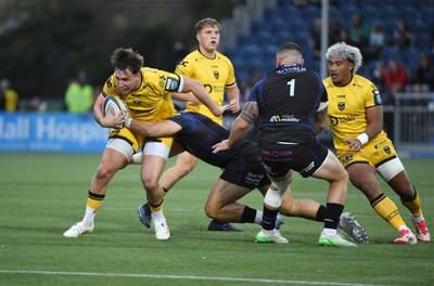 111025 - Glasgow Warriors v Dragons RFC - United Rugby Championship - Harri Ackerman of Dragons tackled by Sione Tuipulotu of Glasgow Warriors