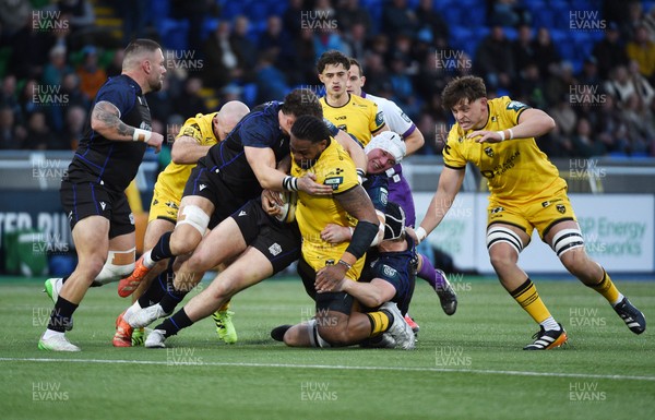 111025 - Glasgow Warriors v Dragons RFC - United Rugby Championship - Levi Douglas of Dragons barges through the tackle of Alex Craig of Glasgow Warriors and Gregor Hiddleston of Glasgow Warriors (headguard)