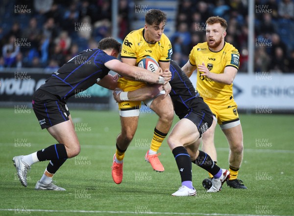 111025 - Glasgow Warriors v Dragons RFC - United Rugby Championship - Harri Ackerman of Dragons tackled by Ollie Smith of Glasgow Warriors and Kyle Steyn of Glasgow Warriors