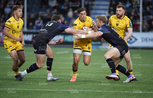 111025 - Glasgow Warriors v Dragons RFC - United Rugby Championship - Harri Ackerman of Dragons tackled by Ollie Smith of Glasgow Warriors and Kyle Steyn of Glasgow Warriors